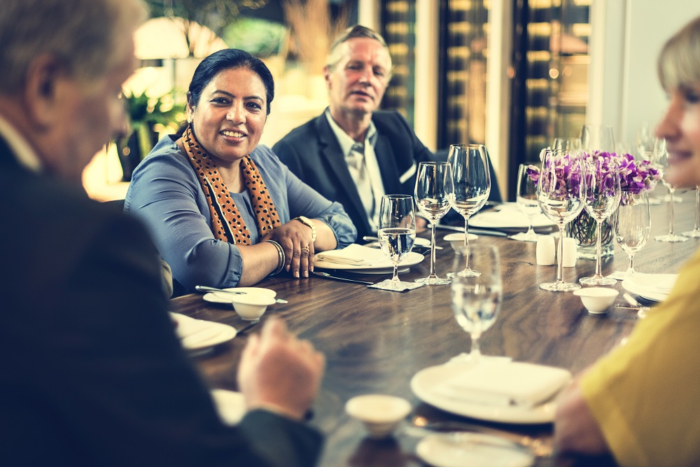 Business People Dining Together Concept Multiracial table of business people having dinner