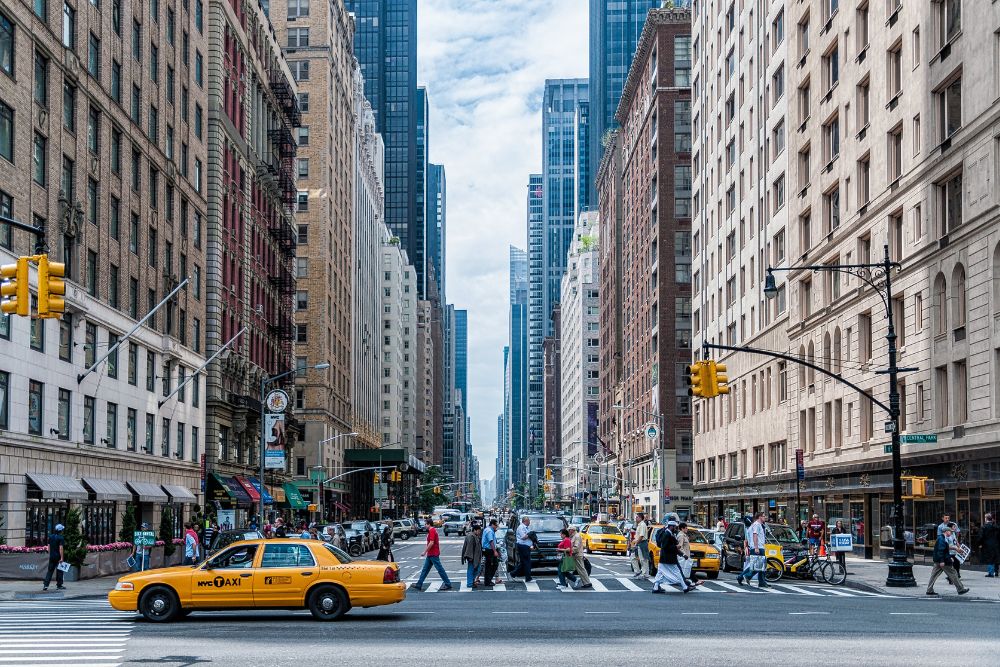 New York business trave New York city scene with taxi and pedestrians crossing the street at a stoplight