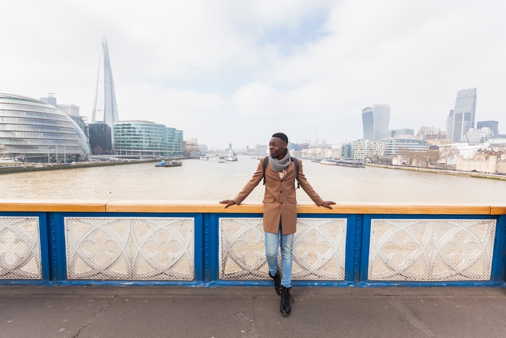 Young black man on Tower Bridge in London Business traveler in London City on the bridge