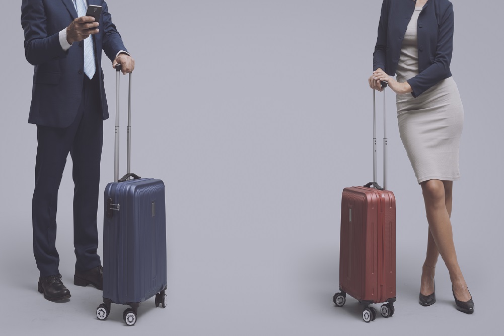 Traveling people standing and waiting what to put in checked baggage vs carry on, baggage