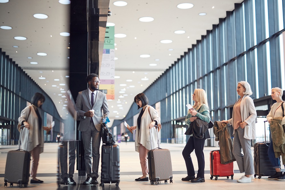 People In Queue At Check-In Counter Passengers waiting on line at Chicago O'hare airport