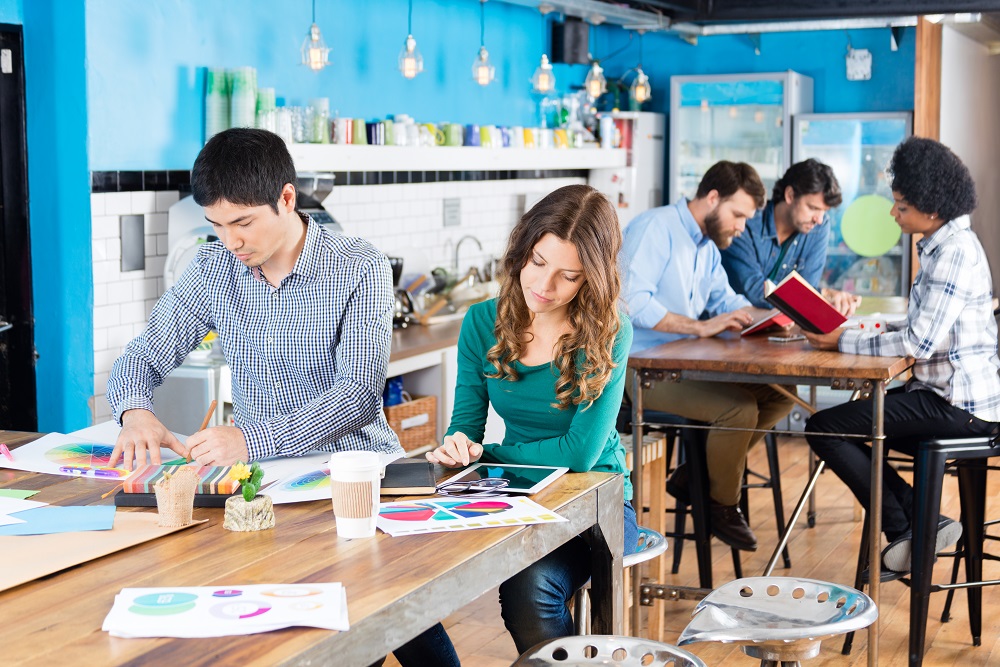 People working office sitting desk modern open coworking space mix race colleagues co-working Austin